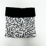 Squeeze pouch measuring approximately 3.25" tall x 3.25" wide. Outer fabric is a black and white floral print with Latin text of the Hail Mary dispersed throughout. Inside accent is a black fabric. Snap frame for easy opening and closing.