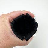 Squeeze pouch measuring approximately 3.25" tall x 3.25" wide. Outer fabric is a black and white floral print with Latin text of the Hail Mary dispersed throughout. Inside accent is a black fabric. Snap frame for easy opening and closing.