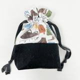 Bl. Pier Giorgi Frassati drawstring pouch; main exterior fabric is white background with Frassati images; black waxed canvas bottom; black lining