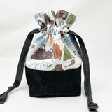 Bl. Pier Giorgi Frassati drawstring pouch; main exterior fabric is white background with Frassati images; black waxed canvas bottom; black lining