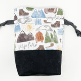 Bl. Pier Giorgi Frassati drawstring pouch; main exterior fabric is white background with Frassati images; black waxed canvas bottom; black lining