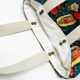 Fully-lined tote bag measuring approximately 8" wide, 9.5" tall, and 2.5" deep. Vibrant multicolored floral print with images of Our Lady of Guadalupe and St. Juan Diego.  Off-white lining. Natural cotton webbing straps.