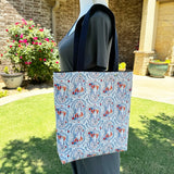 Lined tote bag measuring approximately 12" wide x 14" tall x 2.5" deep. Exterior fabric features white background with colorful Our Lady of Fatima and the three children image. Navy lining. Navy cotton webbing straps.