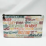 Basic zipper pouch measuring 9.25" wide by 5.25" tall. Exterior fabric features white background with female Saint names throughout. 