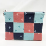 Quilted zipper pouch. Gorgeous watercolor images of Holy Family Hearts with dusty rose, turquoise, and navy backgrounds. Navy lining. White zipper with silver coil.